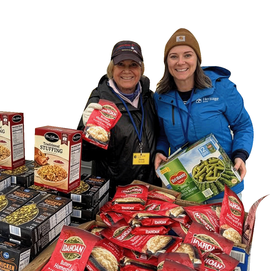 Our friendly food pantry volunteers display healthy boxed food items at the William Temple House outdoor market
